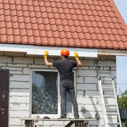 man fixing the gutter