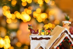 Mini close up adorable santa on the roof with snow.