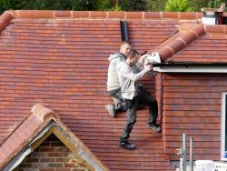 two gutter cleaning professionals