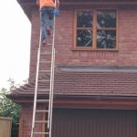 man fixing gutter