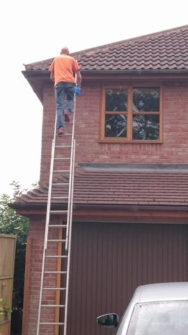 man fixing gutter