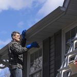 man cleaning soffit and fascia