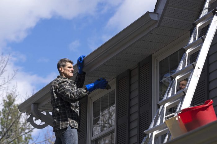 man cleaning soffit & fascia